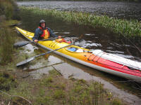 Rest break at grassy bank on Pieman River